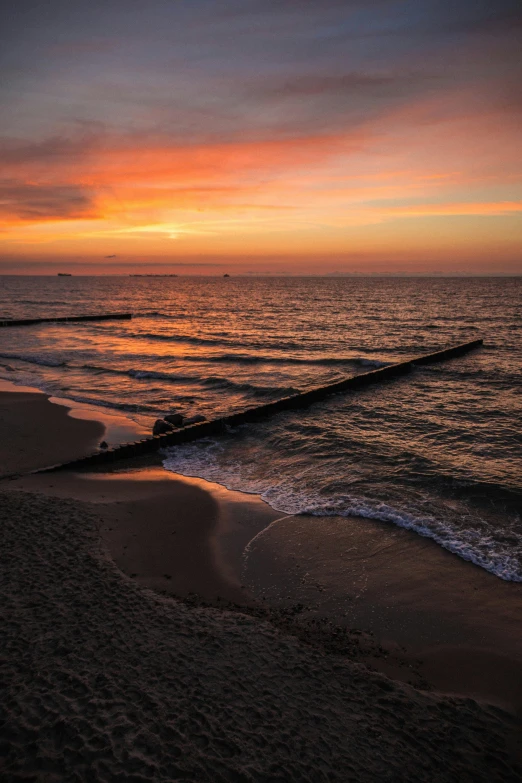 an ocean at sunrise with waves coming to shore