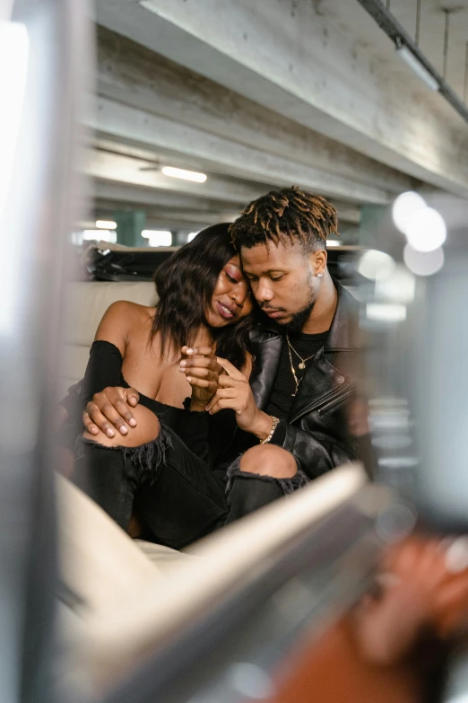 a young man and woman pose for a po in an underground area