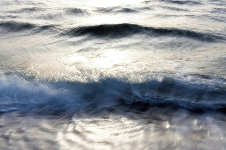 the sky has light reflecting on the water