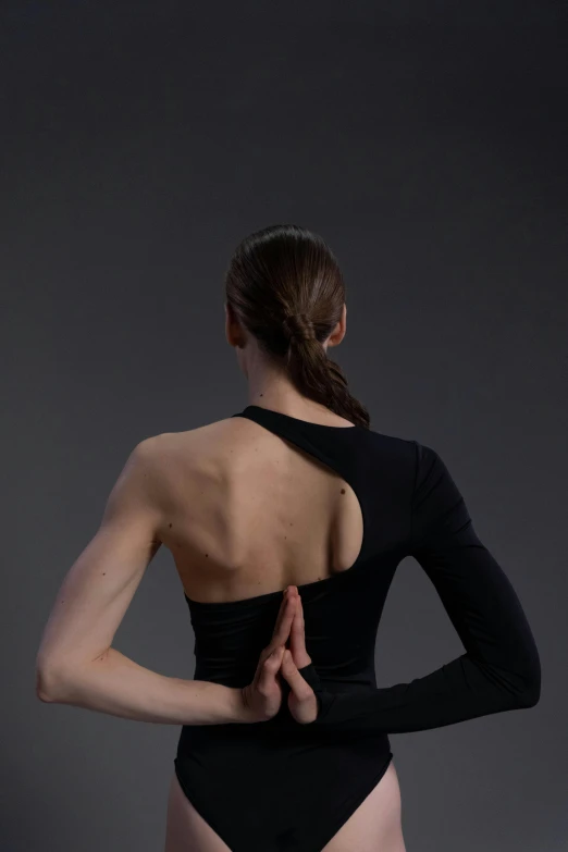 a woman wearing a black leotard is looking at her