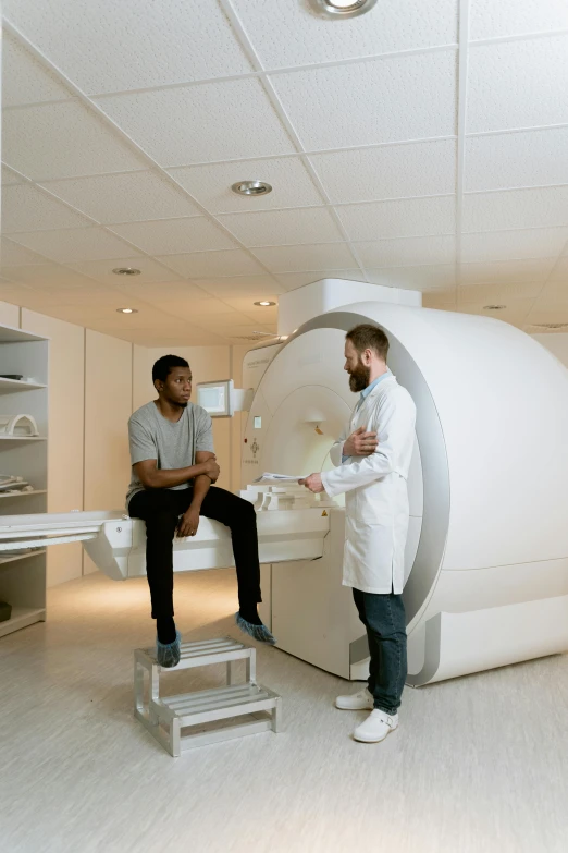 a couple of people that are sitting in front of a machine