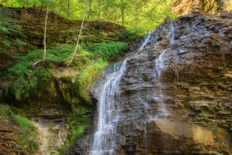 a waterfall with trees in the background