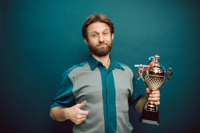 there is a man with a beard holding a trophy