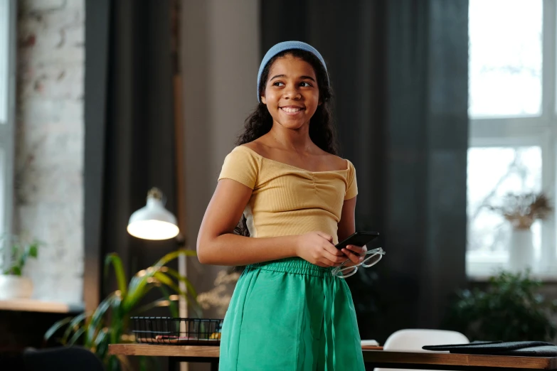 a little girl smiles while standing in an office