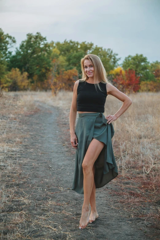 a woman posing for a picture on a path