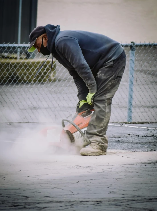 man with safety gloves  a piece of pipe