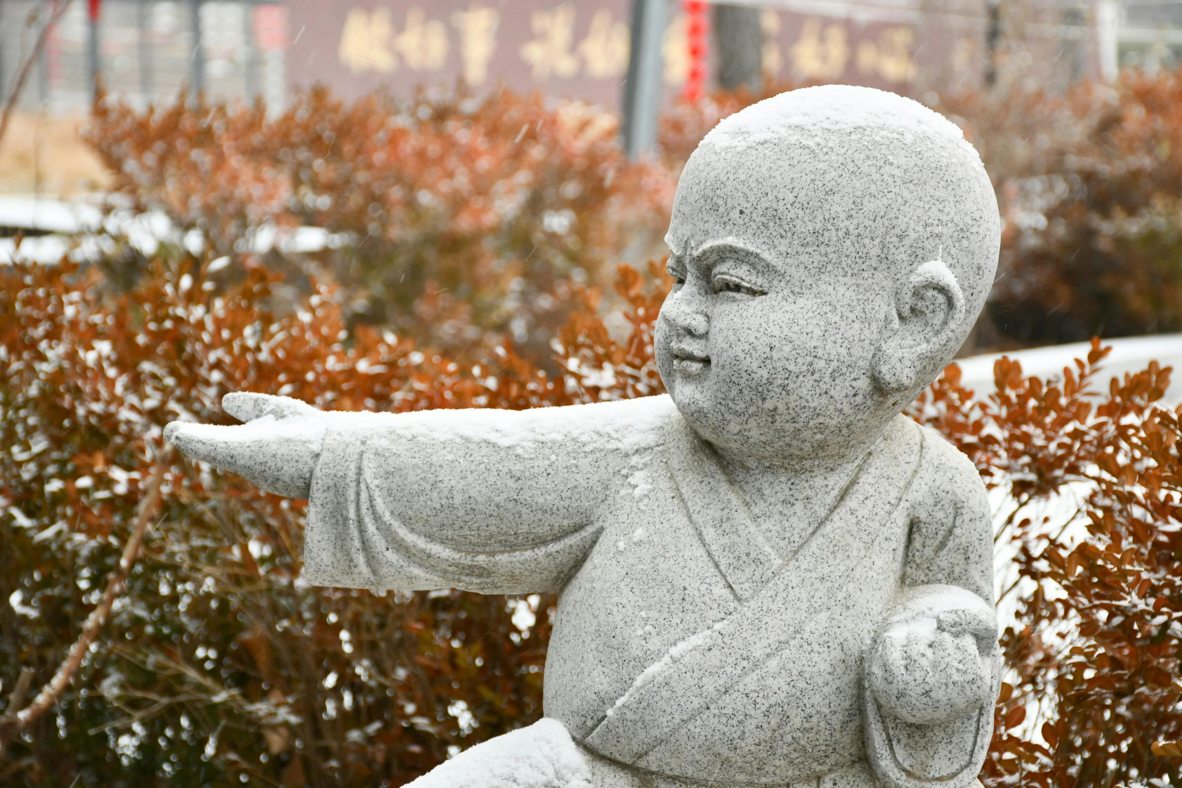 a sculpture of a man with his arms out