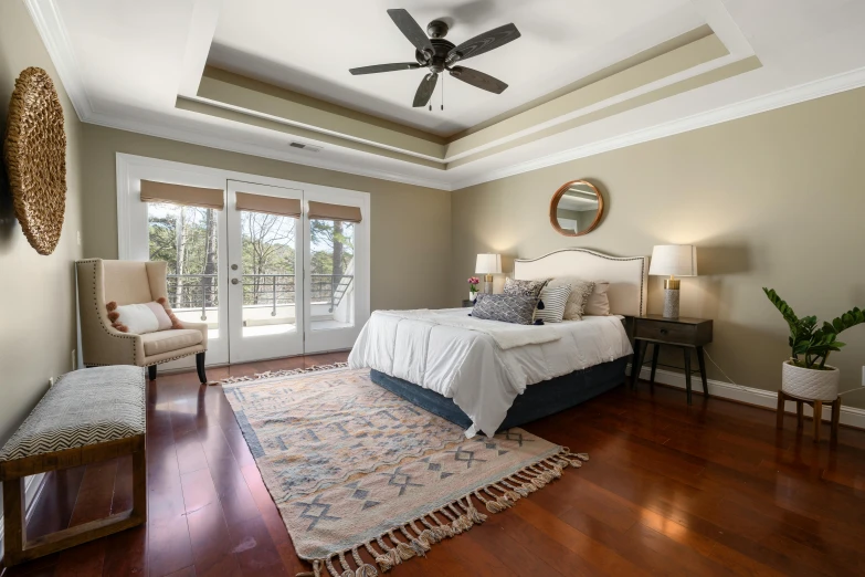 a bedroom with light and a fan with two lamps on each