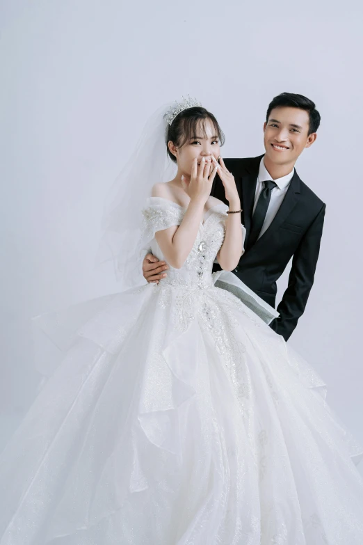 bride in a long white gown standing next to her groom