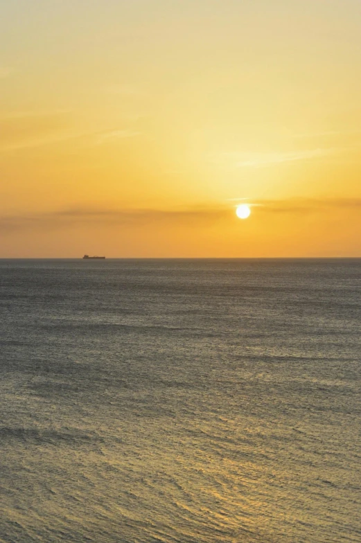 a boat in the distance on a large body of water