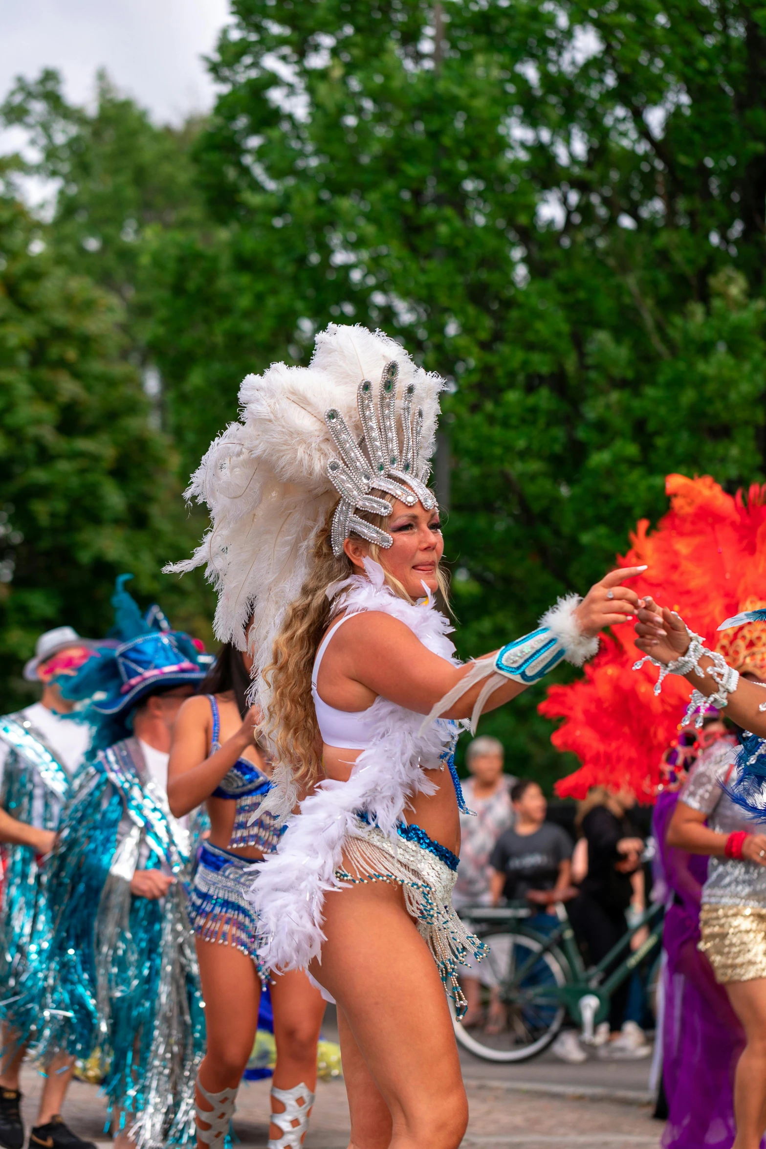 performers in traditional garb perform in a parade