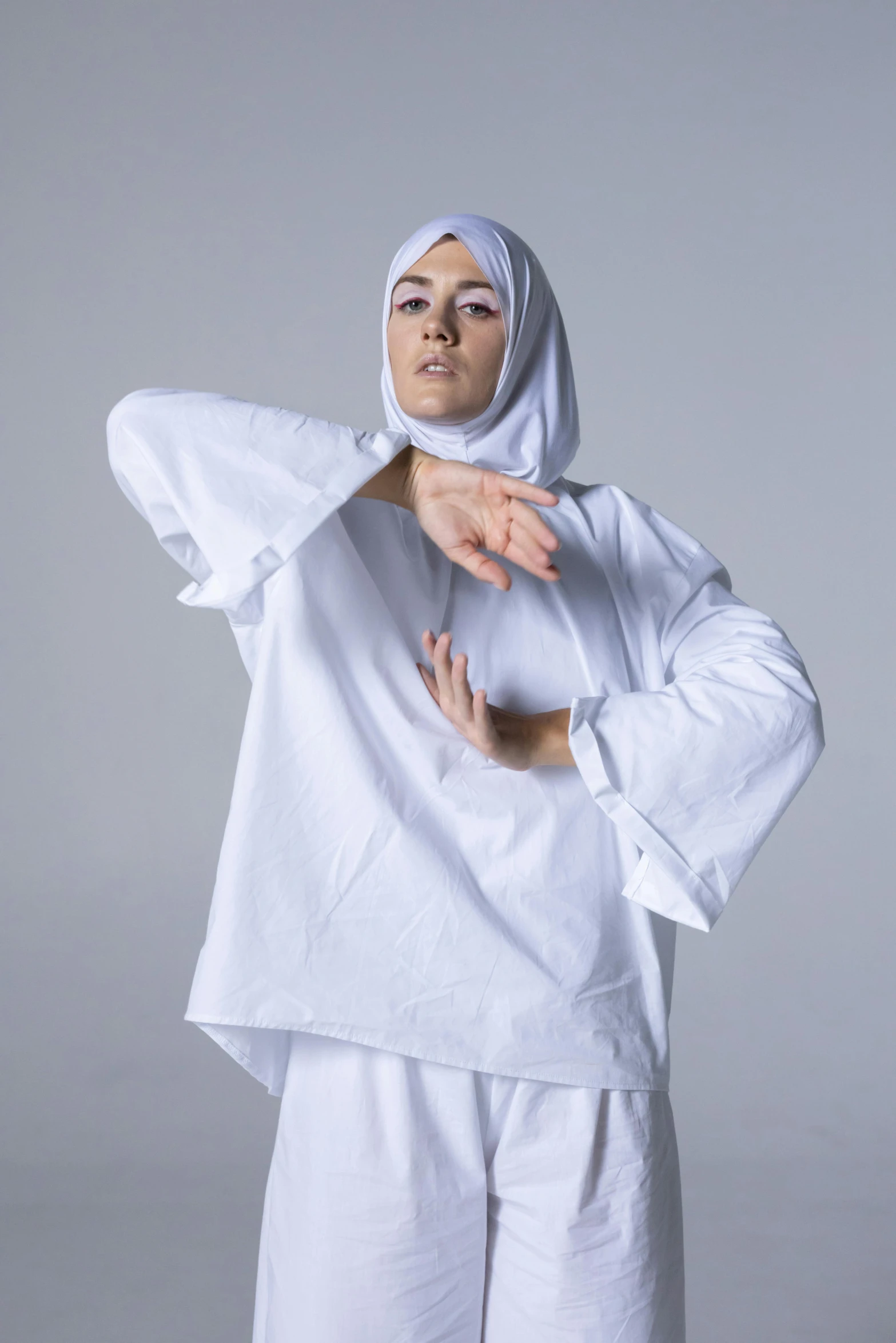 a woman in a white robe posing for a po