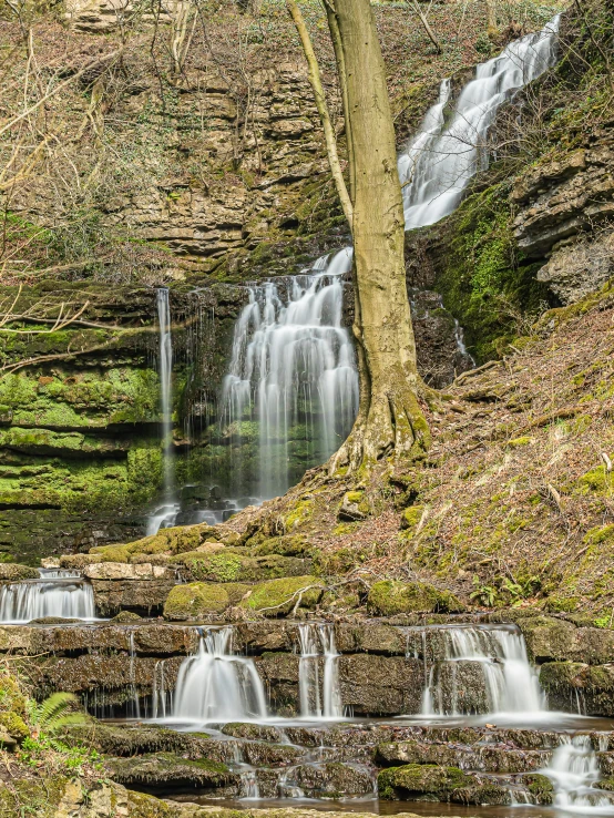 water casings surround waterfalls at the bottom of a canyon