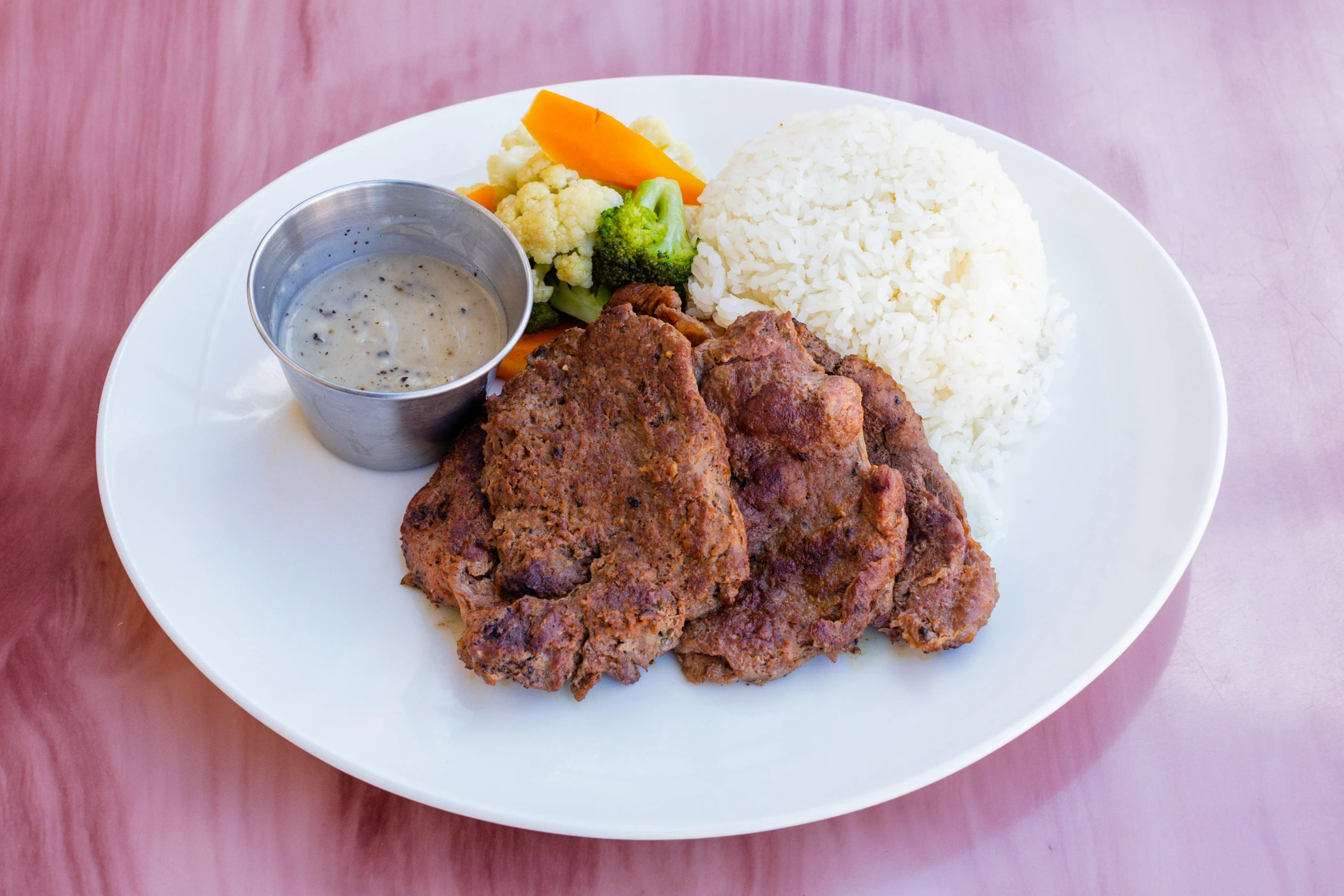 a white plate topped with food and rice