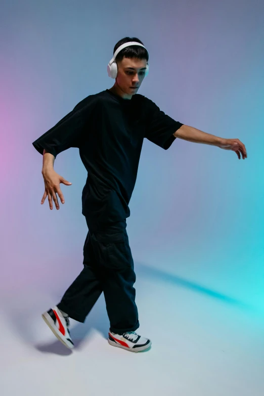 the boy is wearing headphones and dancing on a white background