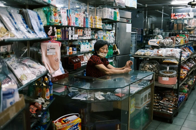 the woman smiles as she stands at the counter at the grocery