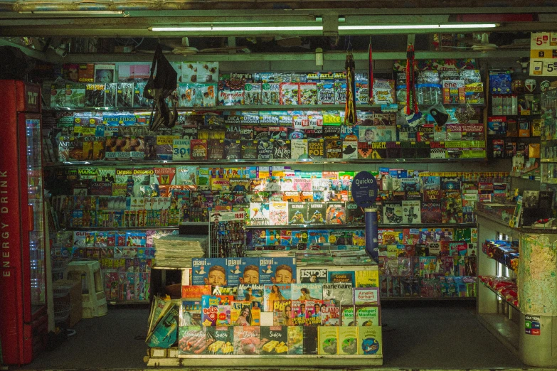 a person standing next to a display of magazines