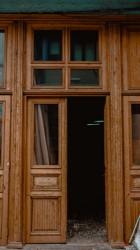 wooden doors in an old building with window frames