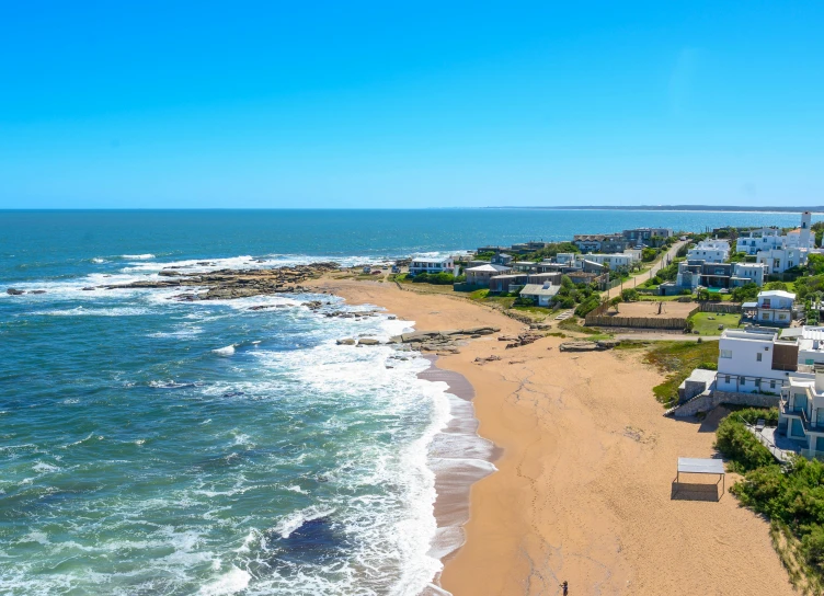 the view from the beach with houses and houses in the background