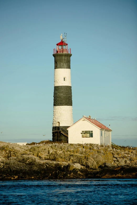 the light house is beside a rock wall