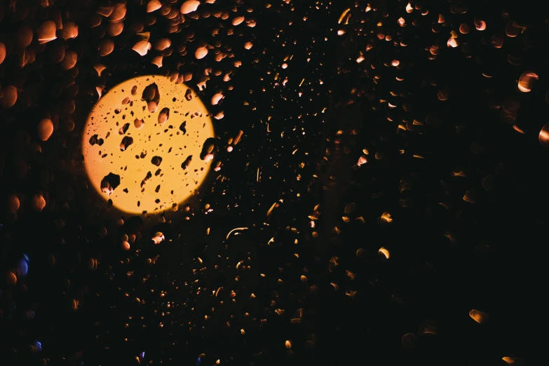 a traffic light reflecting the street light during night