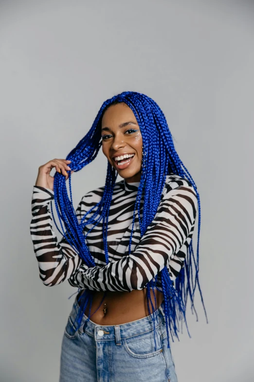 woman smiling with blue twists in her hair