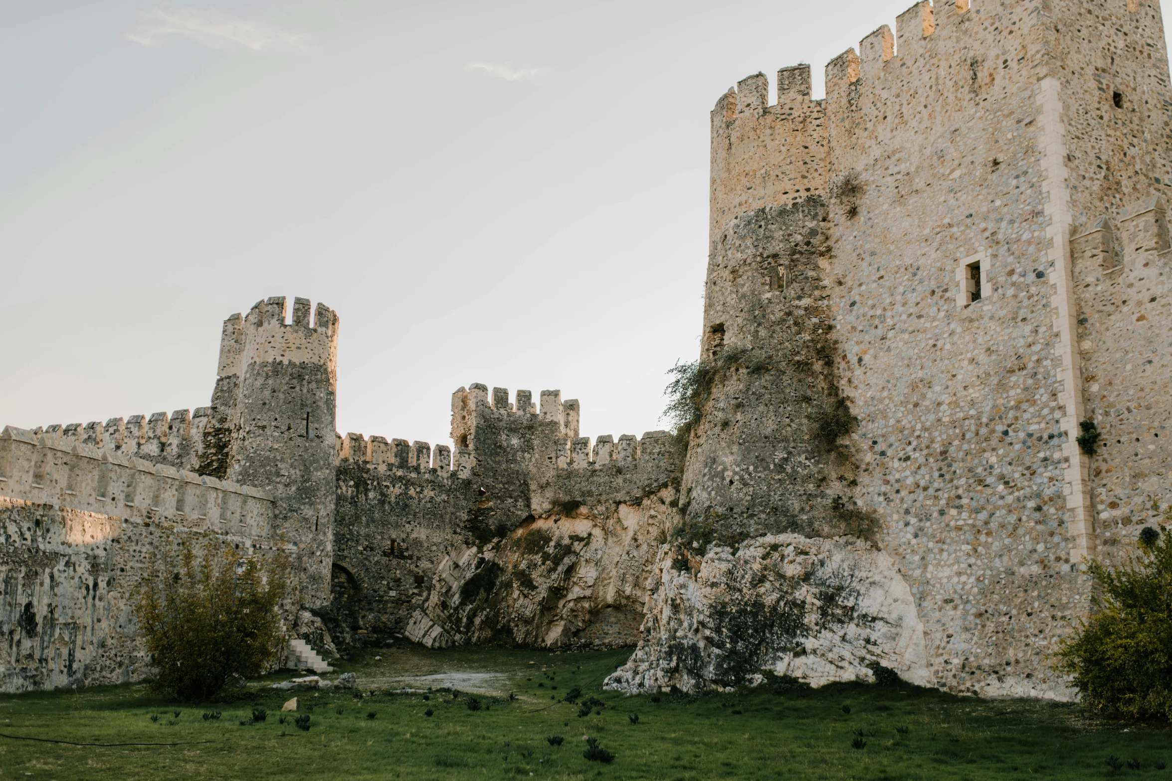 a castle surrounded by a rocky outcrop