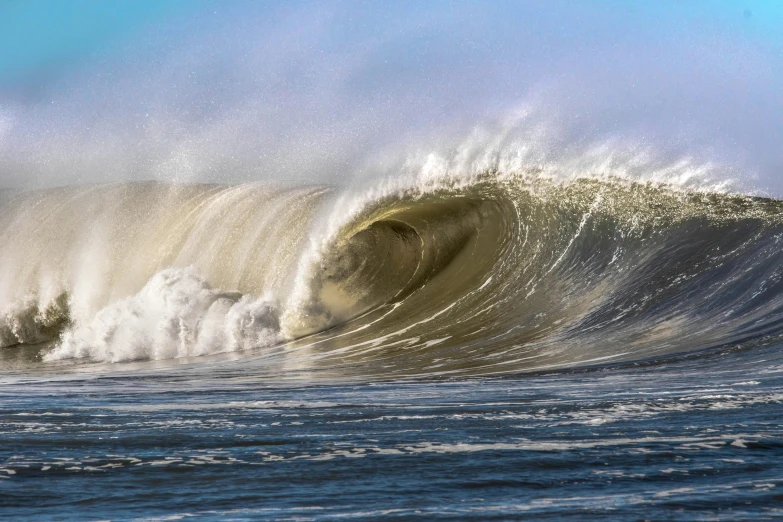 a very large wave crashing in the ocean