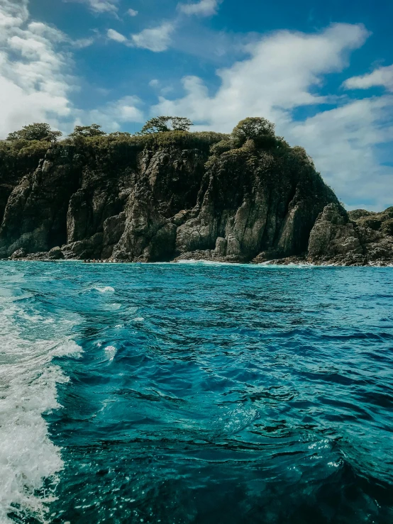 a body of water with some hills in the background