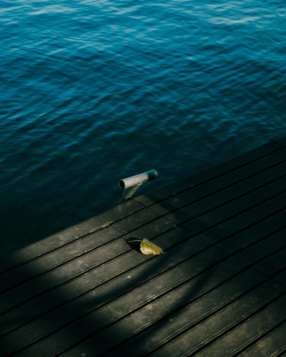 a broken bottle sitting on top of a pier