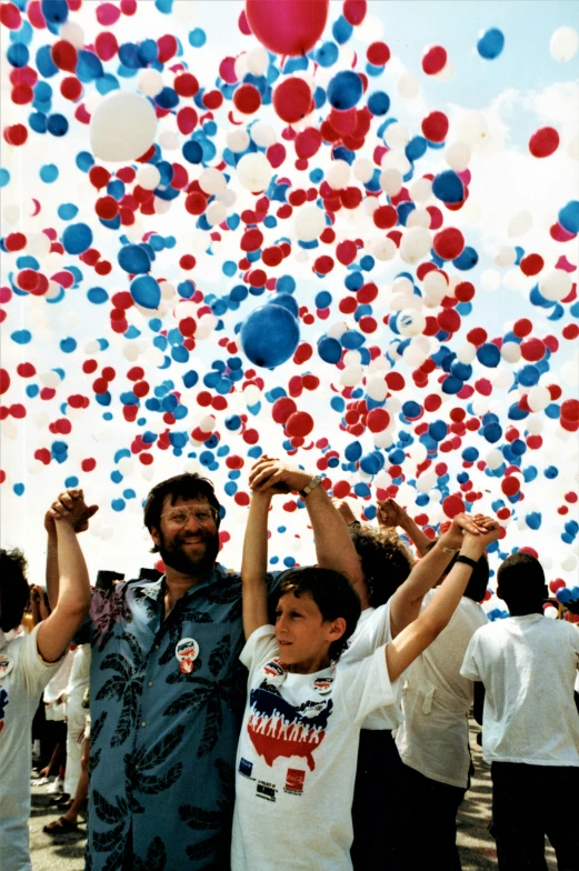 two children and their dad are having fun in a field