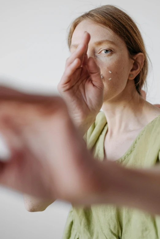 a woman covers her eyes with her hands