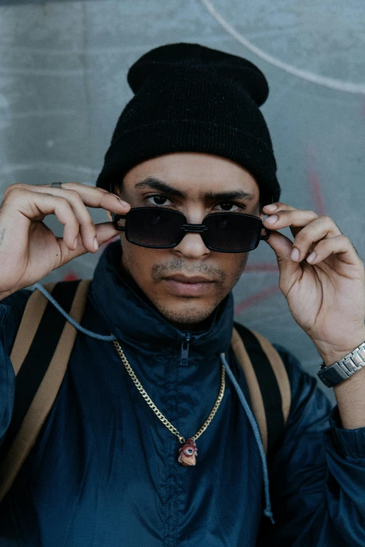 a young man with sunglasses on his ears