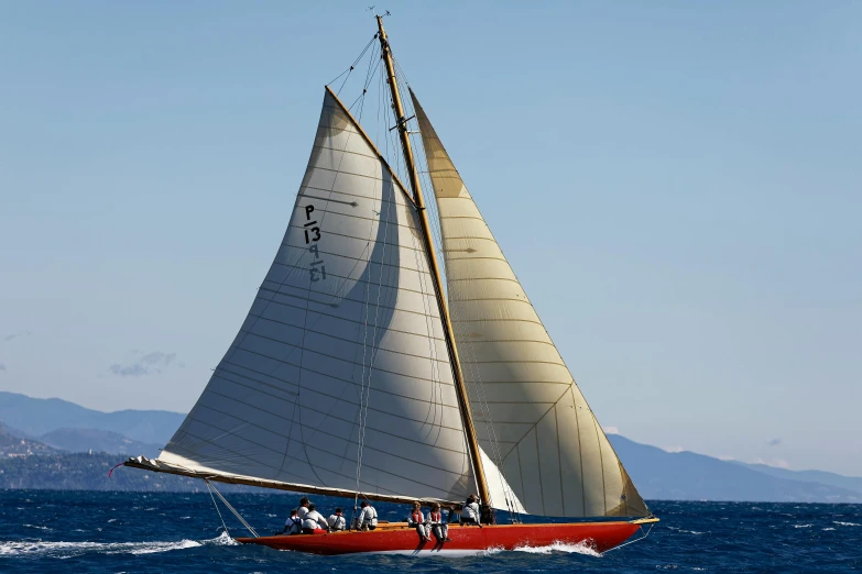 a white sailboat sailing across the ocean