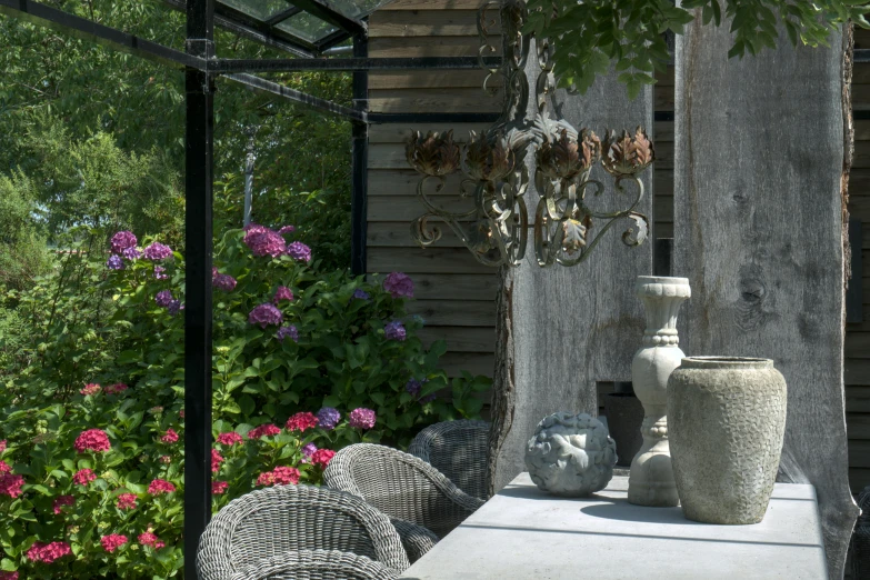 an outdoor table and flowers on a sunny day