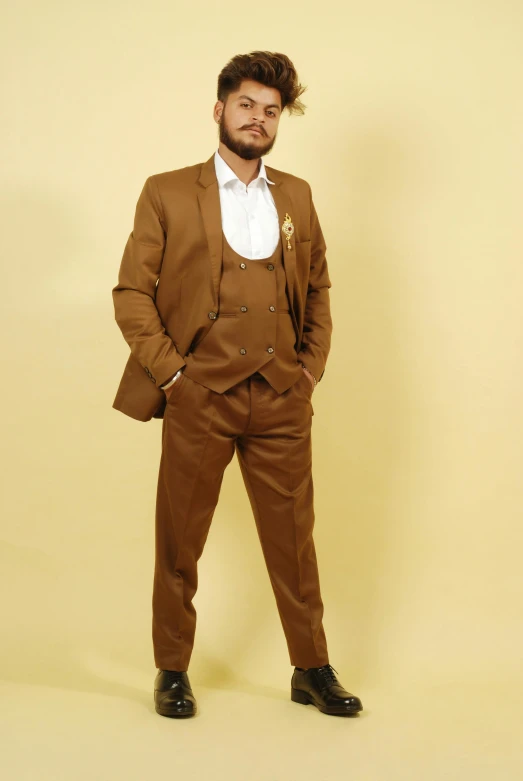 a man in brown suit posing for a picture