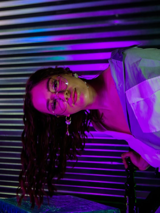 a woman standing in front of some metal slats