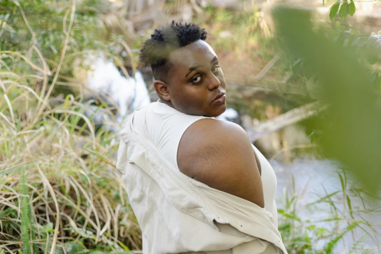 a woman with an afro looking directly at the camera