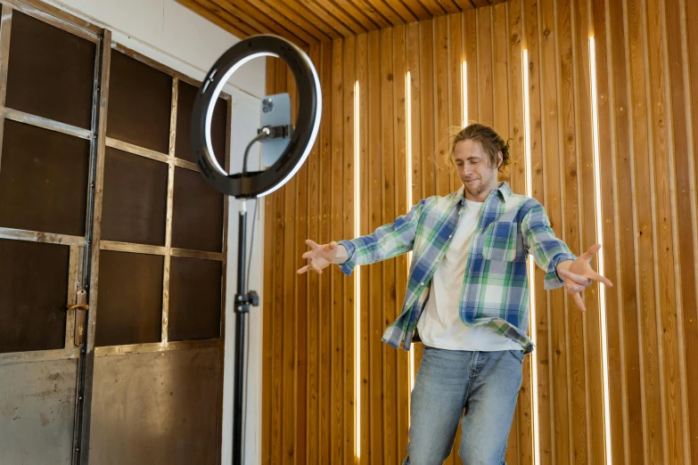 a young man is balancing on the outside of an indoor basketball hoop