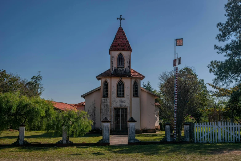 an old church sits next to some trees