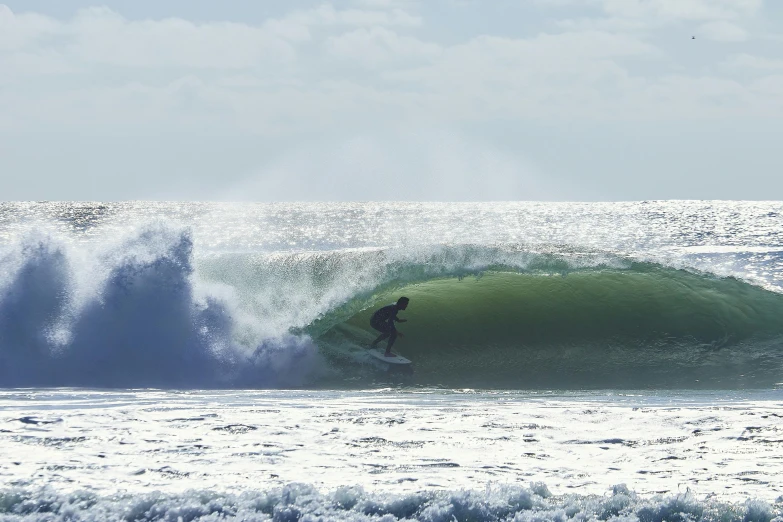 a person riding the waves on a surfboard