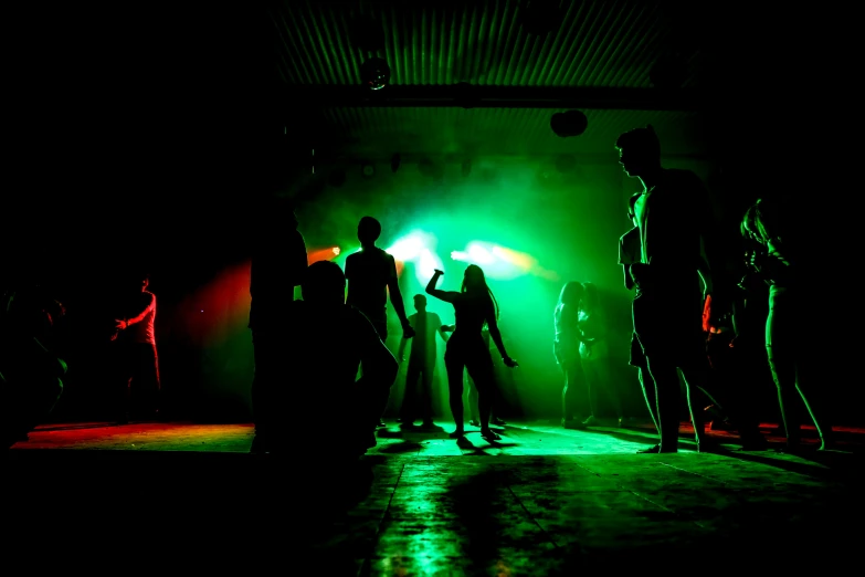 people standing in a dark room with light streaming through their eyes