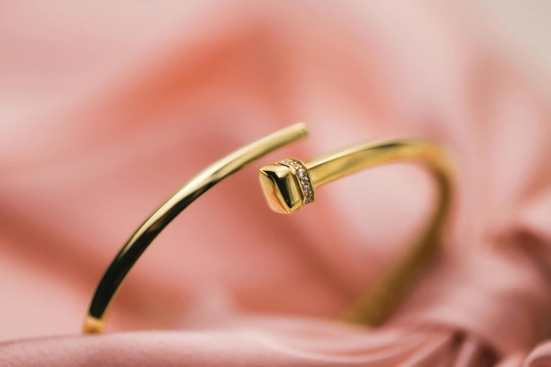 a gold ring that has a diamond on the side of it