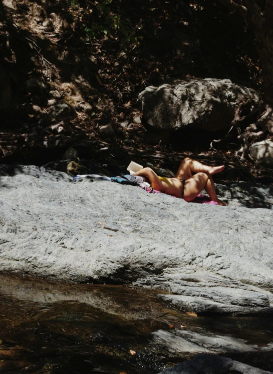 a person is laying on top of the sand