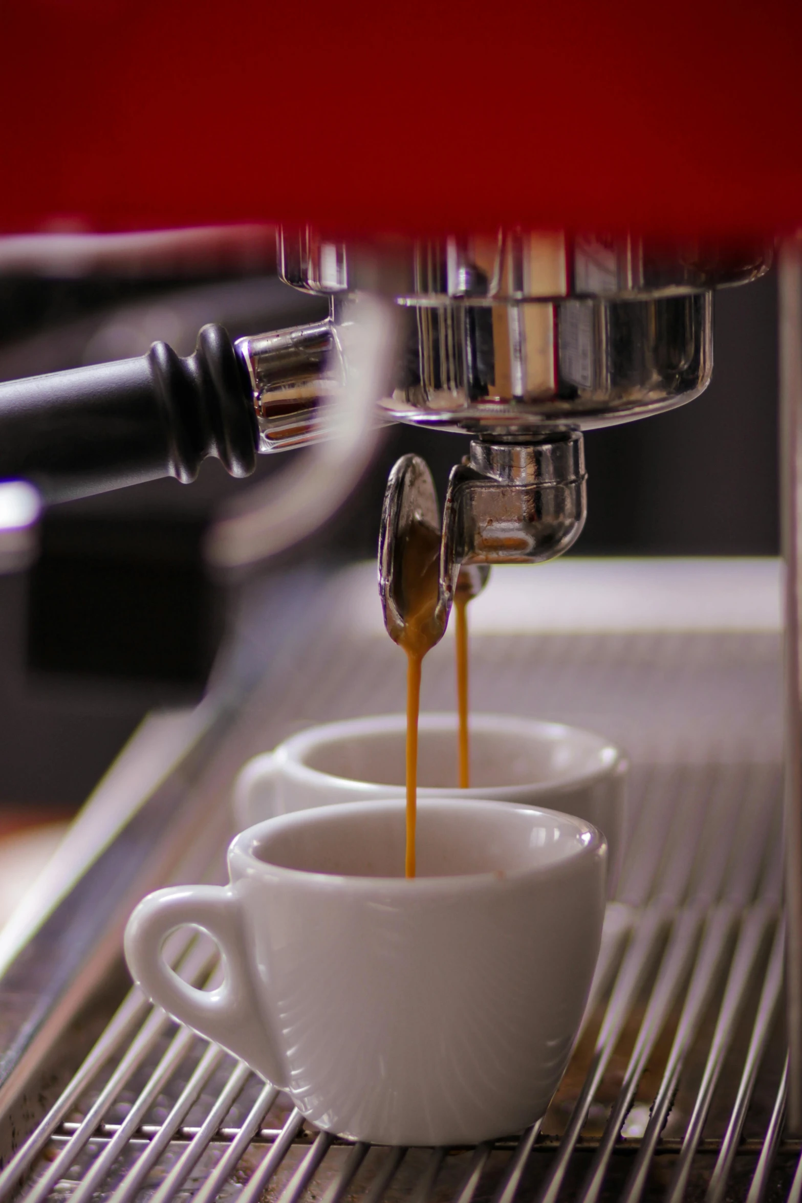 two coffee cups with coffee being made