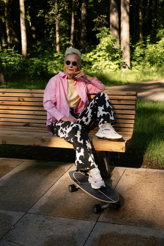 an old woman sitting on a bench on a skateboard