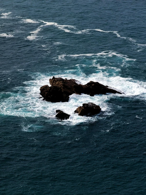 two rocks sit in the middle of the water