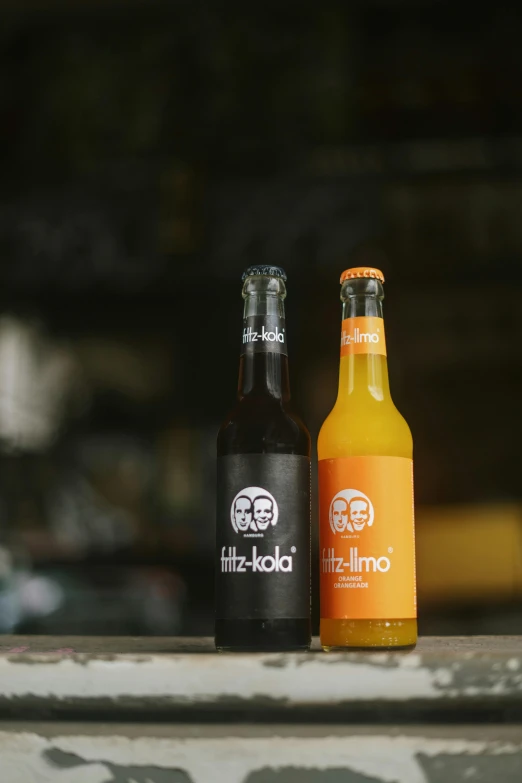 two bottles on top of a white bench