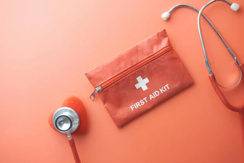 a medical kit on a table with a stethoscope and earplugs