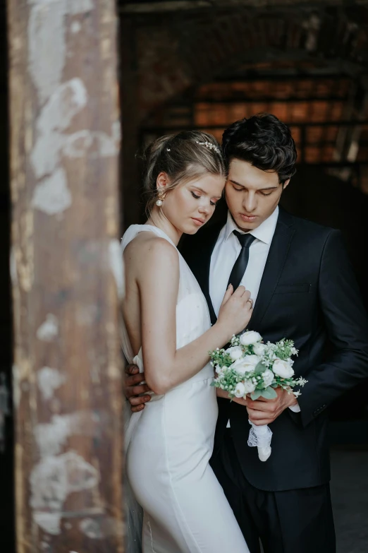 a bride and groom look into each others eyes